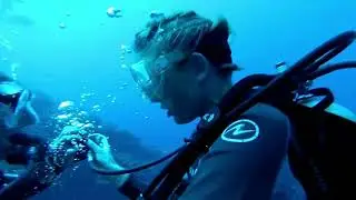 Scuba girl in wetsuit simulates air loss