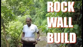 Extending the Rock Wall behind the cabin to prevent erosion