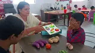 Special children are being taught to identify vegetables.