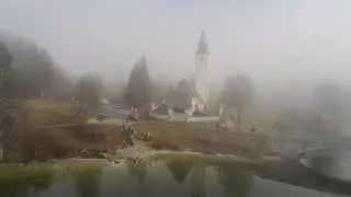 Bohinj Lake. Slovenia. Dec 2023. Flight in fog. Beautiful mountains. Julian Alps. 4k drone video.