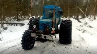 A T-40 on three wheels from a combine harvester being skidded