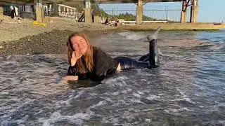 swims in the sea in a hoodie and trousers #wetlook