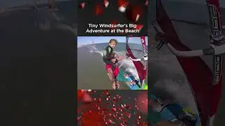 Guy Windsurfs With Little Girl on Shoulders