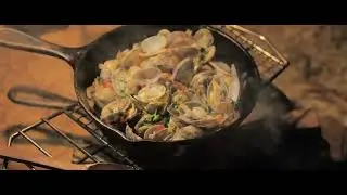 Camping in the wilderness, cooking seafood, a