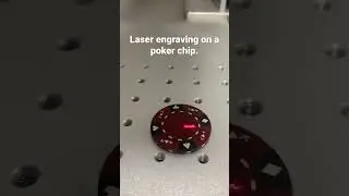 Laser engraving a poker chip.