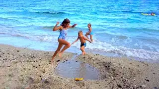 Children play on the beach. Pool on the beach 4K.