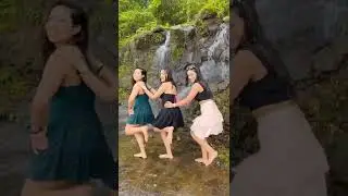 Three Models Dance Near the Waterfall