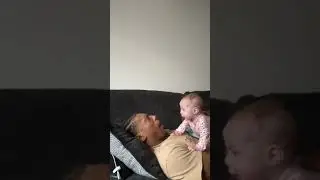 Dad and baby girl are cuddling for a nap on the couch!