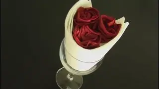 Fold a napkin in the shape of a bouquet of roses
