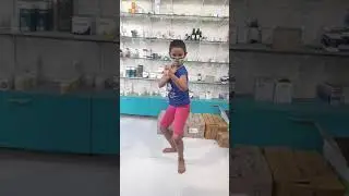 little girl doing karate. full legs stretching