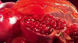 Slow Motion Shot of Pomegranate Juice Splashing through Pomegranate