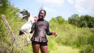 A LADY SLAUGHTERING CHICKEN FOR FOOD IN BOOTS