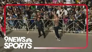 Christian Braun jumps from firetruck to celebrate with Nuggets fans during parade