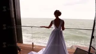 Bride posing at balcony at sea resort hotel