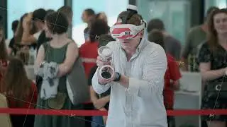 Man experiencing virtual reality with VR headset at tech event
