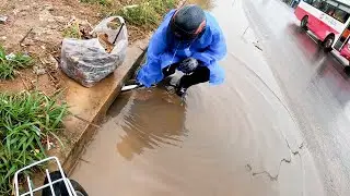 Unclogging Culvert Trash Rack Flood a Street Heavy Rain