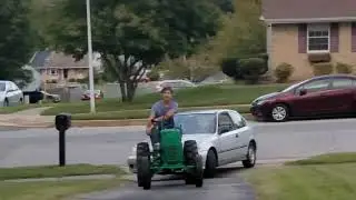 Homemade tractor towing a car uphill