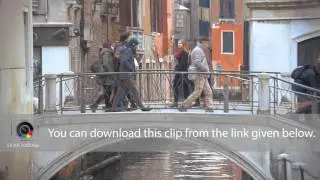 Venice city scene with bridge and walking people