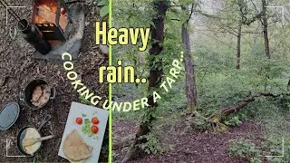 Under the tarp hiding from the deluge. cooking breakfast and chilling.