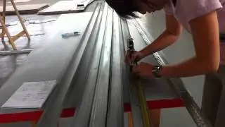 Jill Measuring drywall studs