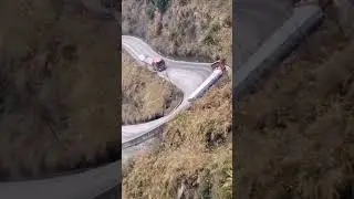 Challenging Curve: Trucks Struggle on Steep Slope