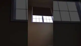 Motorized shade on a high window. Sold and installed by BlindsNH.com