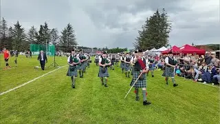 Drum Major leads Ballater Pipe Band playing Cabar Feidh on march during 2024 Dufftown Highland Games
