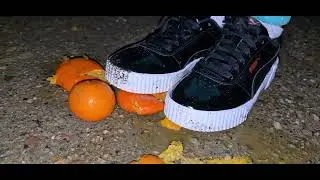 Girl crushing oranges in puma sneakers 