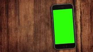Phone with a green screen on the desk. Video background. Stock footage
