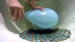 To burst a balloon under water - slow motion