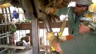 Removal of rods on heat exhanger using induction heating and a hydraulic mechanical puller