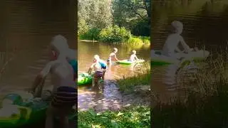 Дети плавают на надувных крокодилах на полигонском пруду