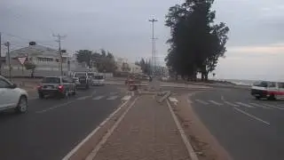 Street vendor lady with hand-cart crossing Maputo's Marginal - very dangerous!
