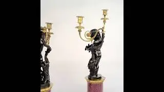 A pair of Egyptian porphyry and bronze candelabra after Charles-Antoine Bridan
