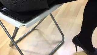 Girl sitting on laptop in sexy mini skirt