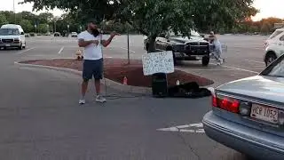 Man Playing Violin In Parking Lot