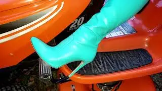 Vivian Ireene Pierce Cranking & Pushing Mowers in Knee High Boots & Leather