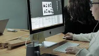 Person with glasses working on a desktop iMac computer | Free stock Mac video