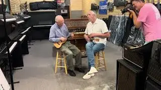 Dr. Thomas Crews taking ukelele lessons from Scott Lansburg at McKibben Music.