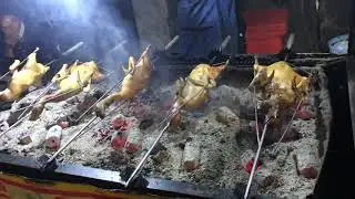 Cambodian Street Food: Rolling duck on fire.