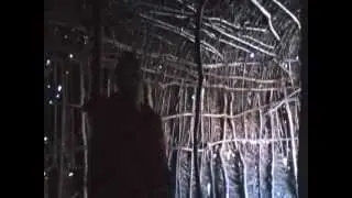 Women making Maasai house in Tanzania with sticks and cow dung