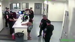 Police Officer tasers handcuffed woman (Security footage)