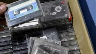 unpacking a box of cassette tapes