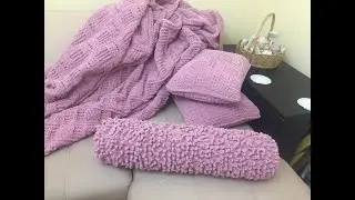 A bolster pillow made from Alize Puffy Fine yarn.