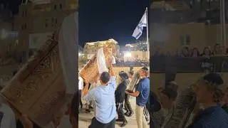 Jews sing and dance with Torah scrolls at the Western Wall.Jerusalem Israel 2025