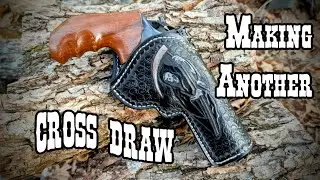 Cross draw revolver holster made western style with a folded belt loop and hammer loop
