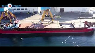 Discharging paper rolls fm sea vessel into covered warehouse