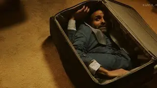 The Man Trapped in a Suitcase, Spewing Gold in Pain.