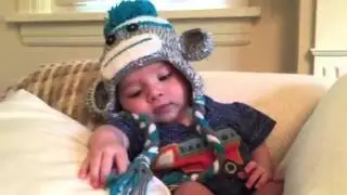 Itty Bitty Twelve Week Baby Talking in a Monkey Hat