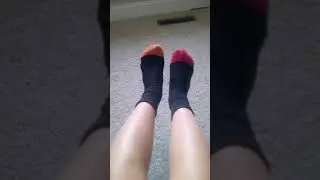 Feet with mismatching socks wiggling